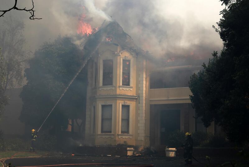 Firefighters attempt to extinguish a burning building at the University of Cape Town. Many university buildings were damaged. AP Photo