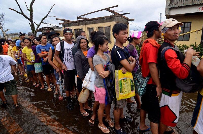 Survivors wait in line to recieve relief goods in an area devastated in Leyte, Philippines. Four days after the Typhoon Haiyan devastated the region many have nothing left, they are without food or power and most lost their homes. Dondi Tawatao / Getty Images