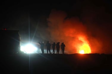 Syrians gather at the still flaming spot where Abu Hassan al-Muhajir, ISIS's spokesman, was reportedly killed n the northern Syrian village of Ayn al Bayda near Jarablus on October 27, 2019. AFP / Aaref WATAD