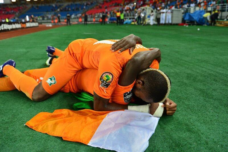 Serey Die of Ivory Coast, above, celebrates with teammate Serge Aurier, below, after they win the 2015 Africa Cup of Nations final in Bata, Equatorial Guinea on Sunday. Gavin Barker / EPA
