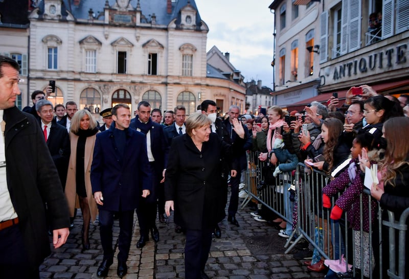 Emmanuel Macron and Angela Merkel are cheered by crowds in Beaune. Reuters