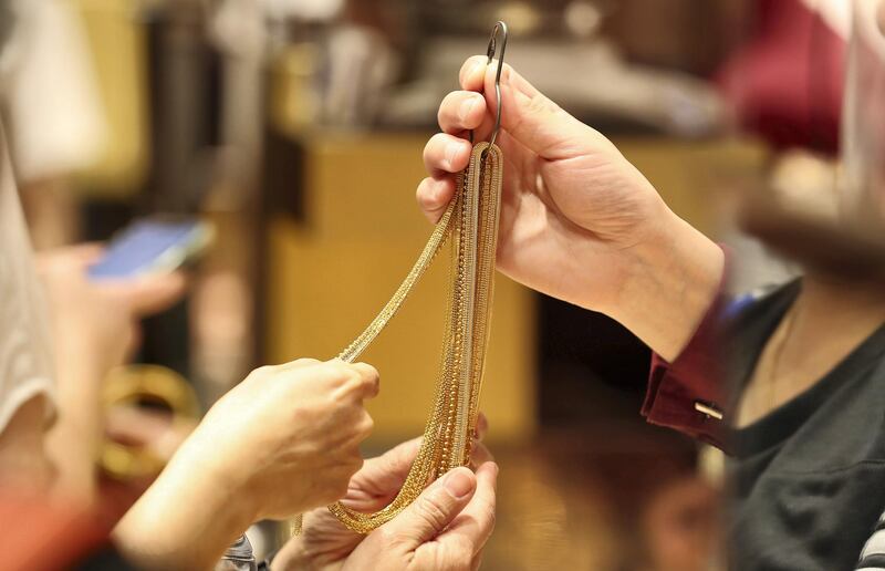 DUBAI , UNITED ARAB EMIRATES , Mar 10 – 2020 :- Customers looking gold chains at one of the jewellery shop in Dubai Gold Souk in Deira Dubai. ( Pawan Singh / The National ) For News/Online Story by Kelly