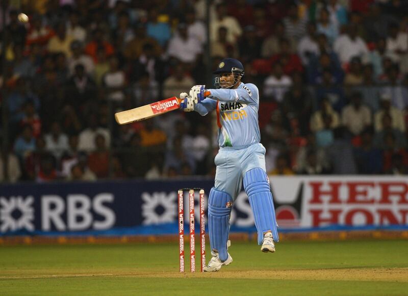 BANGALORE, INDIA - NOVEMBER 23: Virender Sehwag of India hits out at the bowling of Andrew Flintoff  during the 4th One Day International between India and England played at The M.Chinaswamy Stadium on November 23, 2008 in Bangalore, India. (Photo by Julian Herbert/Getty Images)