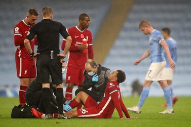 Liverpool's English defender Trent Alexander-Arnold sits on the ground after picking up an injury during the Premier League match against Liverpool at the Etihad Stadium. AFP