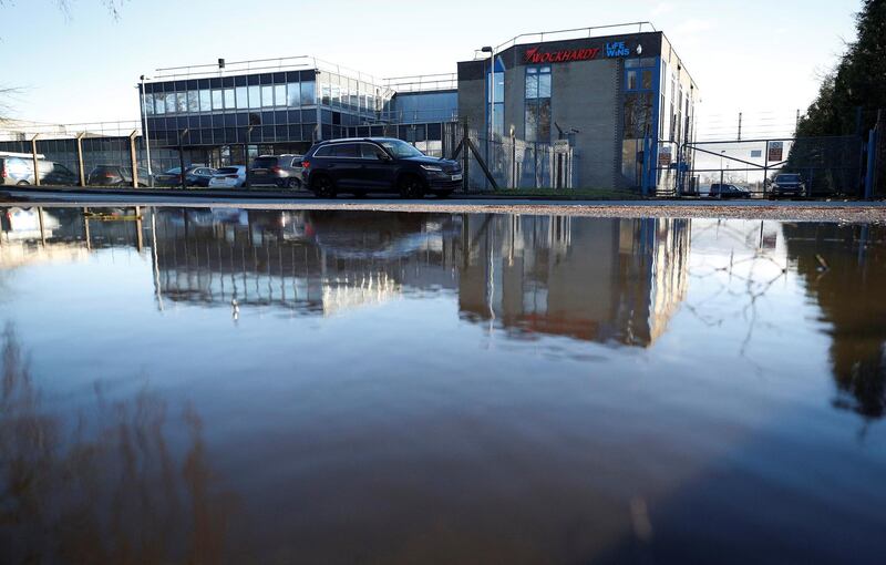 The Wockhardt pharmaceutical plant is reflected in a puddle in Wrexham, Britain January 21, 2021. REUTERS/Phil Noble