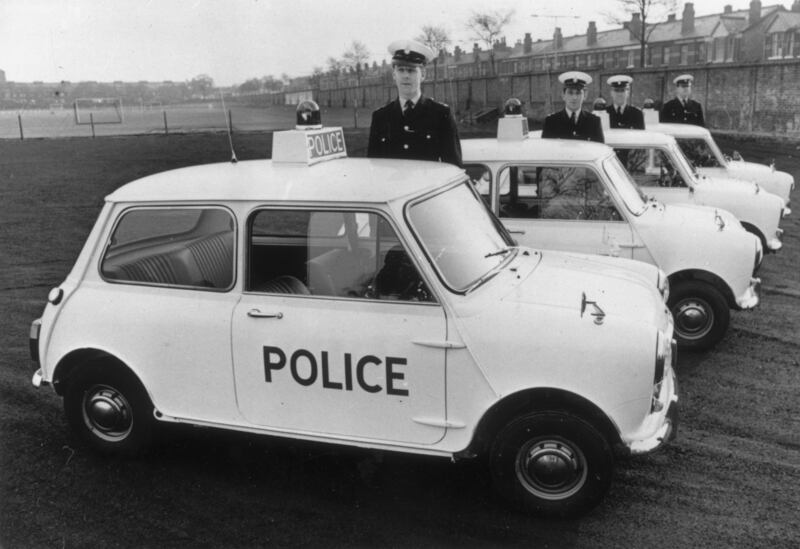 Officers stand by four of the 10 Mini Coopers added to the Manchester police fleet, in 1968. Getty Images