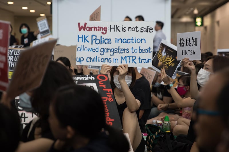 Anti-extradition bill protesters hold signs.  EPA