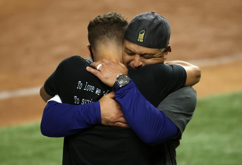Los Angeles Dodgers manager Dave Roberts hugs his son Cole. USA Today