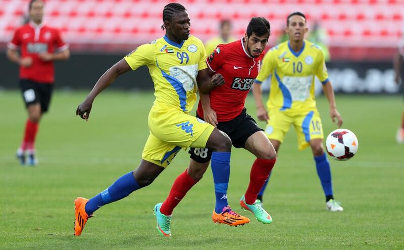 Makhete Diop, left, and his Al Dhafra teammates have gotten the better of Majed Hassan, centre, and Al Ahli of late. Sammy Dallal / The National