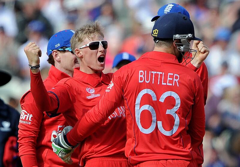 England's Joe Root (C) celebrates after claiming the wicket of Australia's Phil Hughes during the 2013 ICC Champions Trophy cricket match between England and Australia at Edgbaston in Birmingham, central England, on June 8, 2013. England beat Australia by 48 runs in their Champions Trophy Group A opener.  AFP PHOTO/ANDREW YATES   == RESTRICTED TO EDITORIAL USE ==
 *** Local Caption ***  300095-01-08.jpg