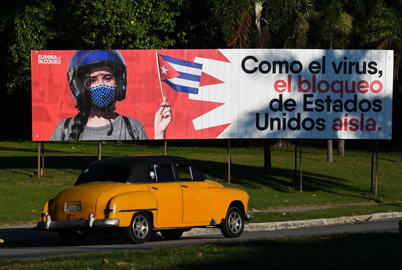 'Like the virus, the United States blockade isolates,' a banner in Havana reads. AFP