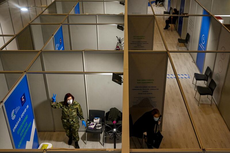 A Greek army medical staff member shows the sign of victory after she gave doses of Moderna Covid-19 vaccine at the vaccination mega center in Athens, Greece. Getty Images