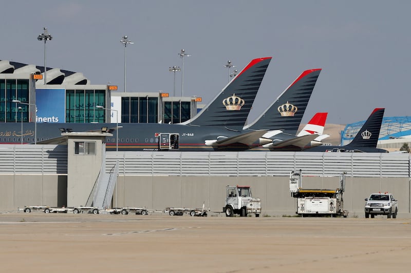 Royal Jordanian Airlines planes and those of other carriers are parked at the Queen Alia International Airport in Amman, Jordan, in February 2020. Reuters