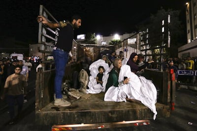 Palestinians arrive at Al Shifa hospital after being wounded by Israeli air strikes in Gaza City. AP