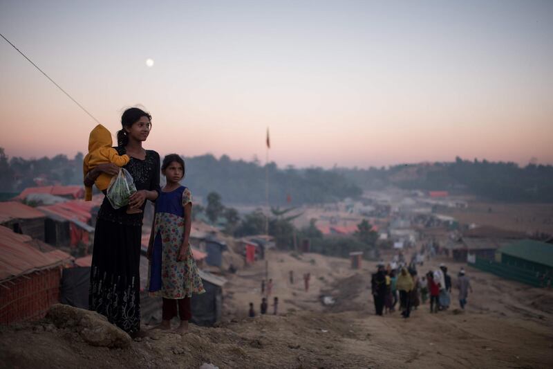 Rohingya migrants stand along a track running through the Thankhali refugee camp in Cox's Bazar. Ed Jones / AFP Photo