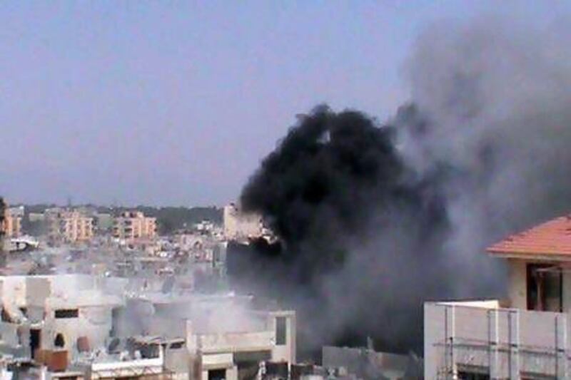 Smoke rises from a building in the Jouret al-Shayyah neighbourhood in Homs.
