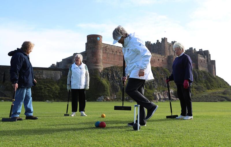 Members of the Bamburgh Croquet club play a game in Northumberland. Reuters