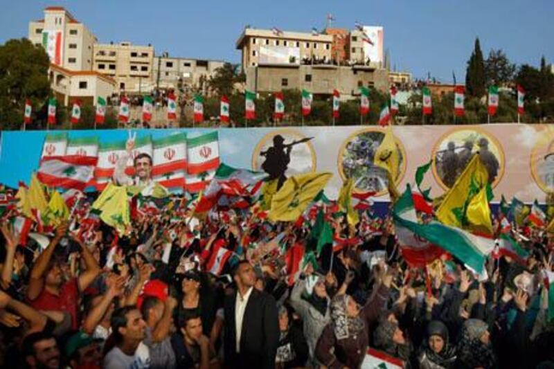 epa02393515 Hezbollah supporters wave Hezbollah, Iranian and Lebanese flags during a rally organized by the Hezbollah for Iranian President Mahmoud Ahmadinejad's visit to Bint Jbeil, southern Lebanon, 14 October 2010. Resistance was the only way to combat Israel, Ahmadinejad said as he concluded his visit to southern Lebanon, close to the Israeli border.  EPA/NABIL MOUNZER