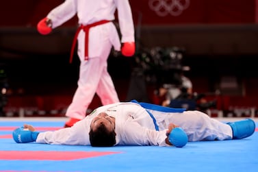 Sajad Ganjzadeh of Iran (bottom) on the ground as he was knocked out by his opponent Greg Hamedi of Saudi Arabia during Men's Kumite -75kg Gold Medal Bout during the Karate events of the Tokyo 2020 Olympic Games at the Nippon Budokan arena in Tokyo, Japan, 07 August 2021.   EPA / HEDAYATULLAH AMID