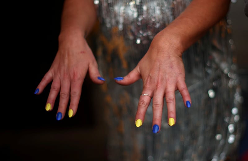 Gemma Abbey, a member of the UK’s 2003 Eurovision entry Jemini, shows off her Ukraine-inspired nails. Reuters