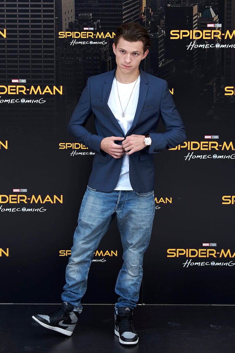 Tom Holland, in jeans, a white T-shirt and navy blazer, attends a 'Spider-Man: Homecoming' photocall in Madrid on June 14, 2017. Getty Images