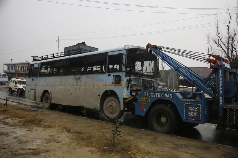 A damaged bus is towed away following an attack on a paramilitary Central Reserve Police Force (CRPF) convoy that killed at least 16 troopers and injured several others near Awantipora town, about 30 kms South of Srinagar, in Lethpora. AFP