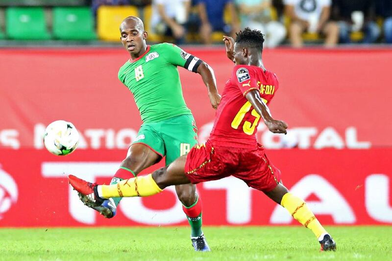 Burkina Faso's midfielder Charles Kabore, left. Steve Jordan / AFP