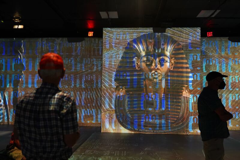 Viewers admire a digital recreation of King Tut's famous golden sarcophagus. Photo: Katarina Holtzapple / The National  