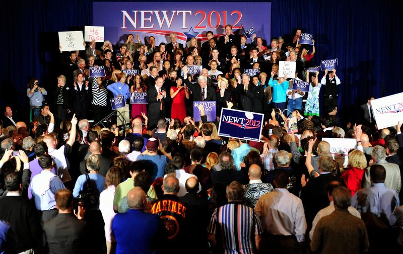 U.S. Republican presidential candidate and former Speaker of the House Newt Gingrich (C) is accompanied by his wife Callista (center R) as he addresses supporters at his Florida primary night rally in Orlando, Florida January 31, 2012.  REUTERS/Octavian Cantilli (UNITED STATES - Tags: POLITICS ELECTIONS) *** Local Caption ***  FLP244_USA-CAMPAIGN_0201_11.JPG