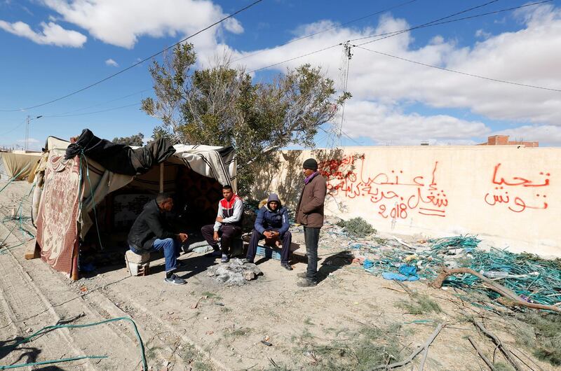 Protesters sit outside a tent near the entrance of the phosphate mine in Umm al-arais, Tunisia February 15, 2018. Picture taken February 15, 2018. REUTERS/Zoubeir Souissi  *** Local Caption *** Protesters are seen near tents  the entrance to the phosphate mine in Umm al-arais