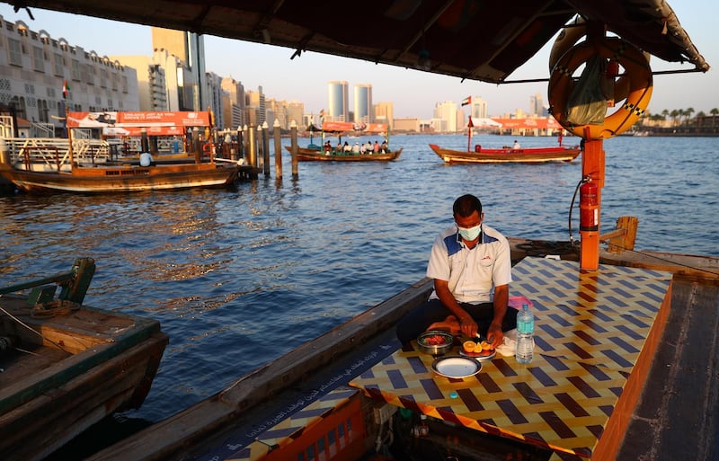 An abra driver prepares an Iftar meal, in Dubai. Getty Images