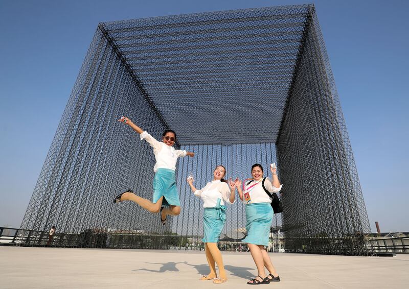 Filipino singers jump for joy as the doors to the world's fair finally open to the public. Chris Whiteoak / The National