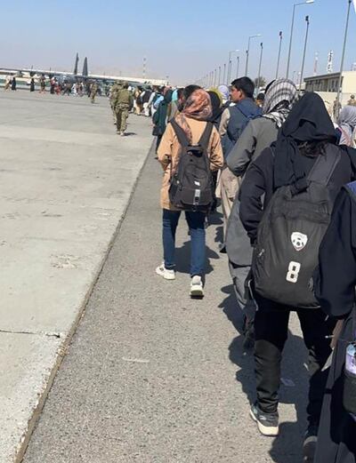 Queueing to leave: members of the Afghanistan Women's football team and relatives and coaches waiting to be evacuated from Kabul airport in August 2021. Photo: Haley Carter