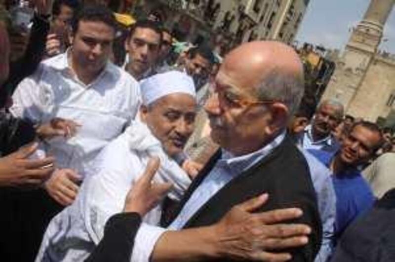 Former U.N. nuclear chief Mohamed ElBaradei is greeted by an Egyptian as he leaves Friday prayers at al Hussien mosque, in Cairo, Friday, March 26, 2010. The ex-U.N. nuclear chief who has emerged as an opposition leader in Egypt had urged the government to respond to peaceful demands for change, cautioning it could face a popular uprising if it doesn't. (AP Photo/Ahmed Ali) *** Local Caption ***  CAI101_Mideast_Egypt_Opposition_ElBaradei.jpg