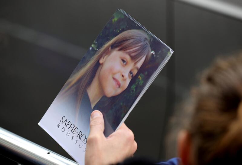 MANCHESTER, ENGLAND - JULY 26:  A man holds a thank you note from the family of Saffie Roussos to the those attending the funeral of the young Manchester Attack victim outside Manchester Cathedral on July 26, 2017 in Manchester, England. Saffie Rousso, aged eight, from Lancashire was the youngest victim of the Manchester sucide bombing attack at the Ariana Grande concert in May. The funeral of Saffie is the last of the 22 victims of the bombing.  (Photo by Christopher Furlong/Getty Images)