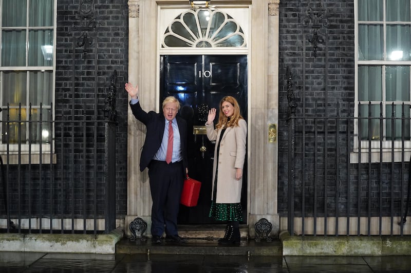 Mr Johnson and his partner Carrie enter Downing Street as the Conservatives celebrate a sweeping election victory in December 2019. Getty Images