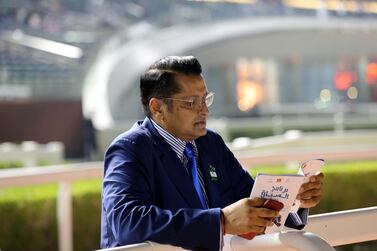 Dubai, United Arab Emirates - October 24, 2019: Trainer Satish Seemar looks at the race card before the Arabian Adventures race on the opening meeting of the new season. Thursday the 24th of October 2019. Meydan Racecourse, Dubai. Chris Whiteoak / The National