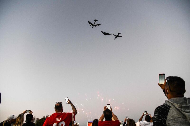 Football fans watch a flypast by US Air Force B-52H Stratofortress, B-2 Spirit and B-1B Lancer bombers at the Raymond James Stadium in Tampa, Florida, during the Super Bowl match between the Kansas City Chiefs and Tampa Bay Buccaneers. AFP