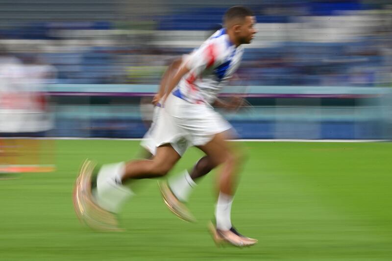 Kylian Mbappe warms up ahead of the Qatar 2022 World Cup Group D football match between France and Australia at the Al-Janoub Stadium in Al-Wakrah, south of Doha. AFP