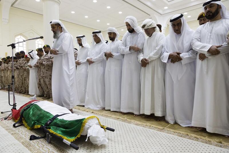 Sheikh Mohammed bin Saud Al Qasimi, Crown Prince of Ras Al Khaimah, takes part in funeral prayers for serviceman Hassan Abdullah Al Bishir in Sheikh Zayed Mosque in Ras Al Khaimah on Wednesday. Duncan Chard for the National