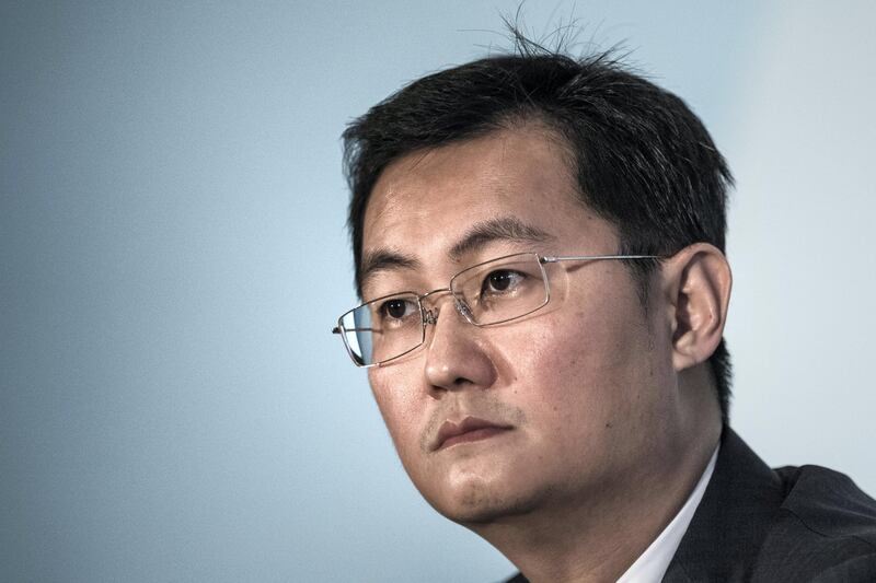 China Internet giant Tencent Holdings CEO Ma Huateng looks on during the announcement of the company's fourth-quarter results in Hong Kong on March 18, 2015. Tencent said its net profit was up 54 percent at 3.82 billion USD (23.81 billion yuan) in 2014 helped by "rapid development" of mobile gaming and social networking. AFP PHOTO / Philippe Lopez / AFP PHOTO / PHILIPPE LOPEZ