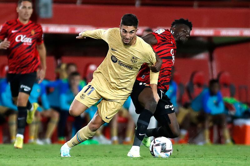 Barcelona forward Ferran Torres vies for the ball with Mallorca midfielder Iddrisu Baba. AFP