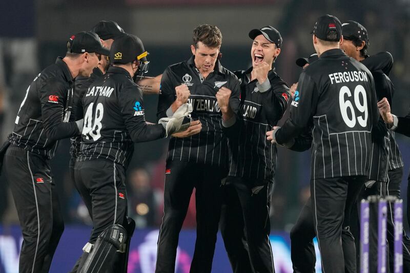 New Zealand's Mitchell Santner, centre without cap, celebrates with teammates after the dismissal of India's KL Rahul. AP 