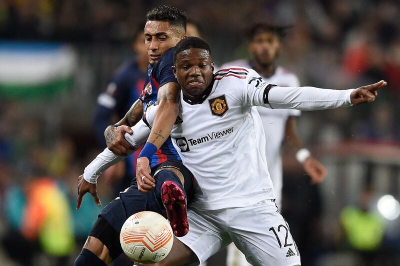 Barcelona's Brazilian forward Raphinha fights for the ball with United's Dutch defender Tyrell Malacia. AFP