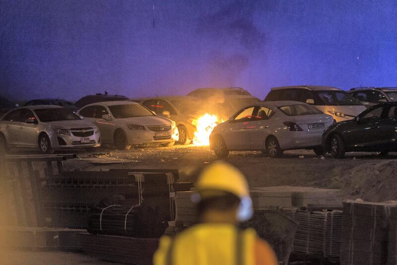 DUBAI. UNITED ARAB EMIRATES, 04 AUGUST 2017. A massive fire rips through The Marina Torch tower's southern corner. Flaming debris falls in an adjacent informal car park next to the building setting parked cars on fire. (Photo: Antonie Robertson) Journalist: None. Section: National.