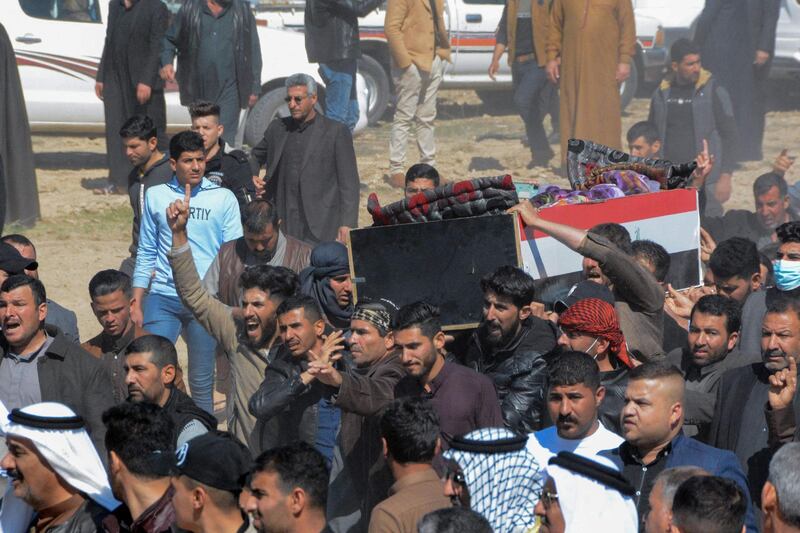 Iraqi mourners pray at the funeral of eight people killed in attacks claimed by ISIS. AFP