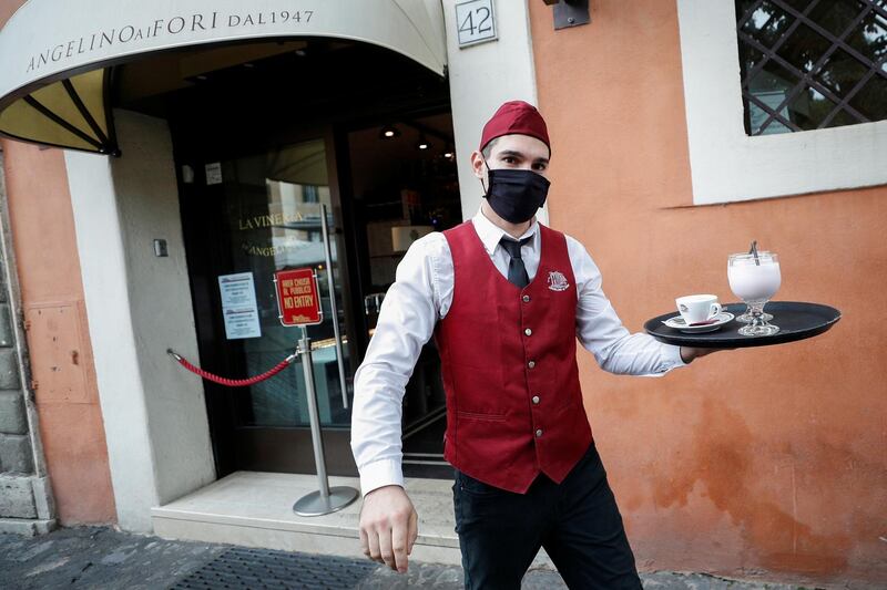 A waiter carrying a tray in Rome. Reuters