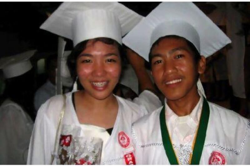 Jaymar Santillan, right, graduated from high school in April this year and is now a first-year accounting student at university.