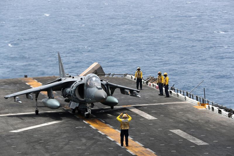 A US Navy officer directs the AV-8B Harrier aircraft.