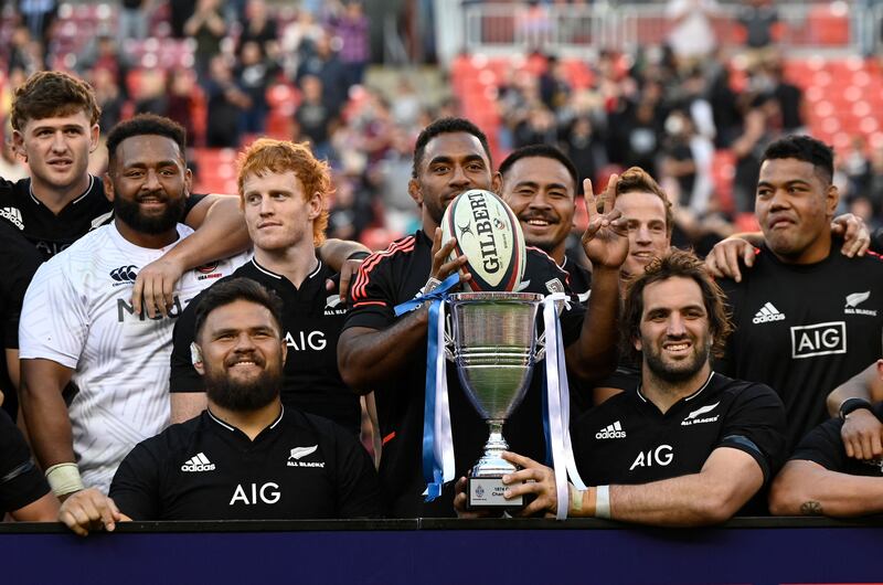 The All Blacks celebrate with the trophy. AFP